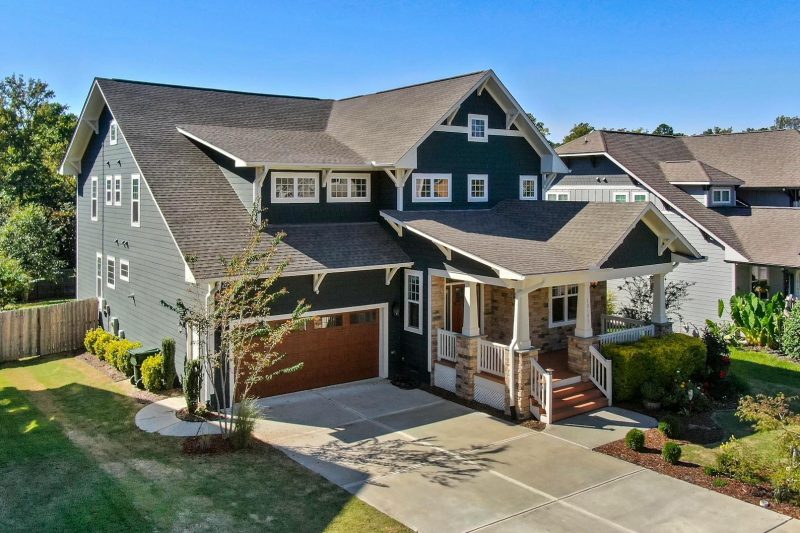 Craftsman-style house with a spacious porch and manicured lawn in Raleigh, NC.