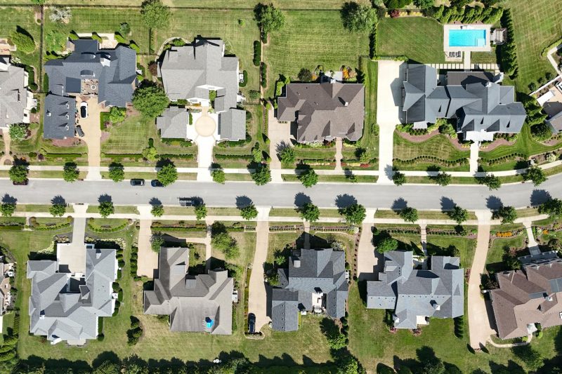 Overhead view of modern homes in a lush, green suburban Tennessee neighborhood.