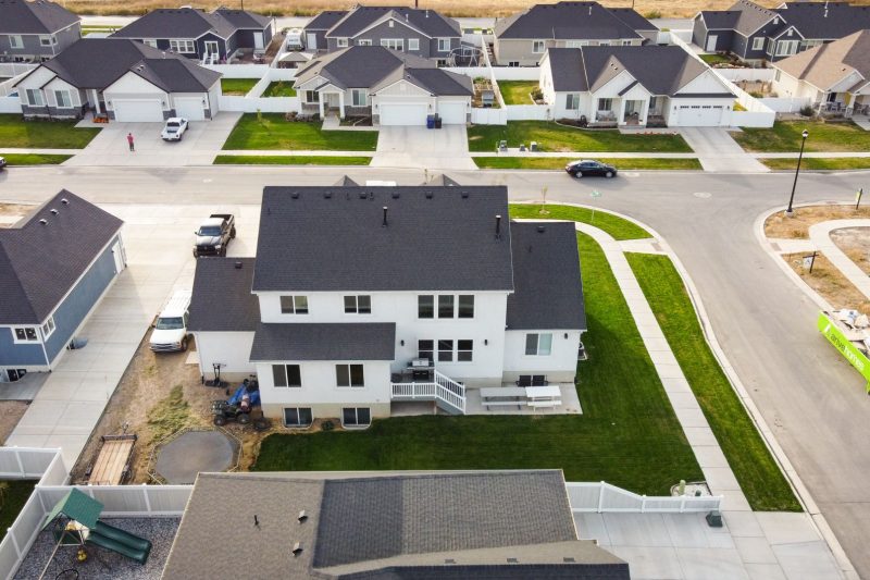 Learning Center 1 Aerial view of a suburban neighborhood in Spanish Fork, Utah, featuring modern homes and green lawns.